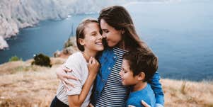 mom hugging a teen and a tween