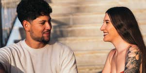 guy and girl sitting on steps chatting