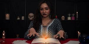 woman at table performing psychic reading