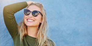 woman wearing sunglasses smiling 