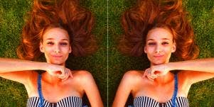 mirrored image of happy woman lying on the grass