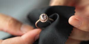 person cleaning diamond ring