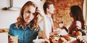 upset woman in the kitchen with friends