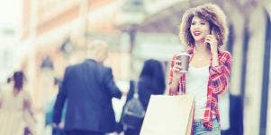 woman on the phone with shopping bags