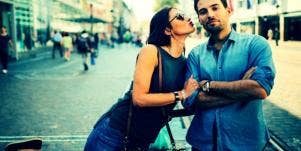 woman leaning over to kiss negative spouse