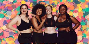 4 women feeling confident about their bodies standing in front of a colorful background