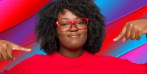 woman in red top in front of colorful background pointing to herself