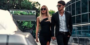 fancy couple dressed up walking holding hands