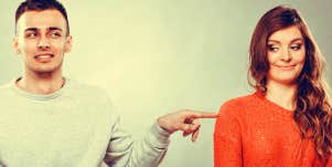 Shy woman and man sitting on sofa couch next each other