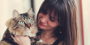 woman holding cat