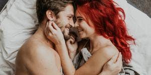 man and woman looking at each other in bed