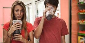 couple drinking large sodas