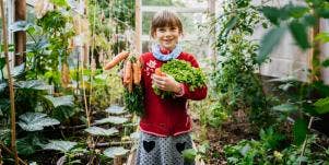 smiling girl holding carrots