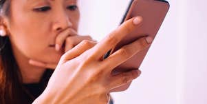 woman looking through phone trying to figure out if someone went through it