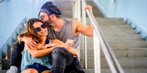 man kissing a woman on the stairs