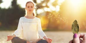 woman meditating with bay leaves