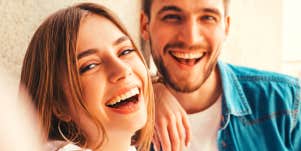man and woman smiling at the camera