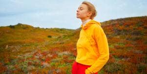 relaxed woman in yellow sweater outdoors