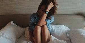 upset woman sitting in bed