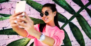 woman taking a selfie with her phone