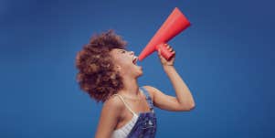 woman holding a speaker