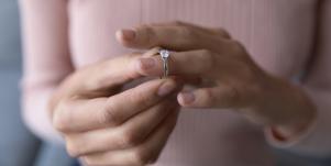 woman touching her engagement ring