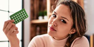 woman holding pack of birth control pills