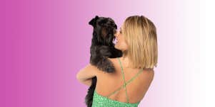 Woman carrying dog 