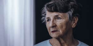 elderly woman looking out window