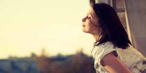 woman looking out the window 