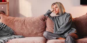 sad woman sitting on couch