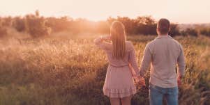 couple holding hands in the wild