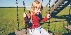 little girl crying on swing