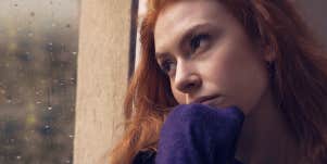 woman leaning against the window