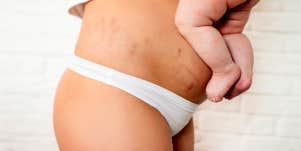 post partum mom holding baby