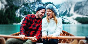couple in a rowboat in a snowy canyon lake