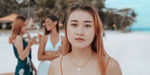 woman with two friends laughing behind her