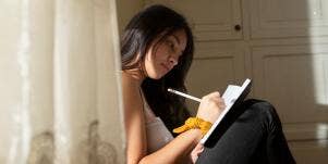 woman writing on a journal