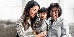 mom and grandmother holding child