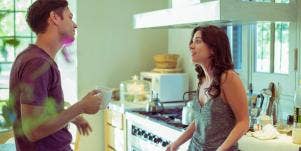 man and woman talking in a kitchen