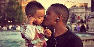 father kissing his son
