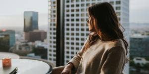 woman looking out window