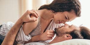 smiling couple in bed