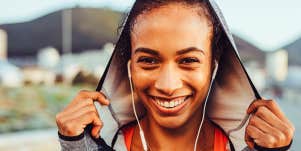 Smiling African-American woman shown during her workout