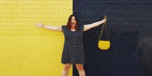 woman standing in front of black and yellow wall