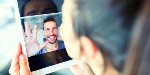 woman looking at boyfriend on ipad