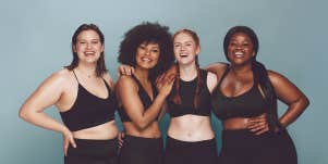 four woman with different skin color and body shape standing together 