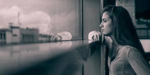 woman looking out window