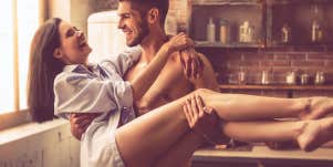 man holding up a woman