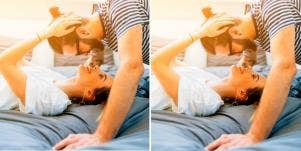 man leaning over woman laying down